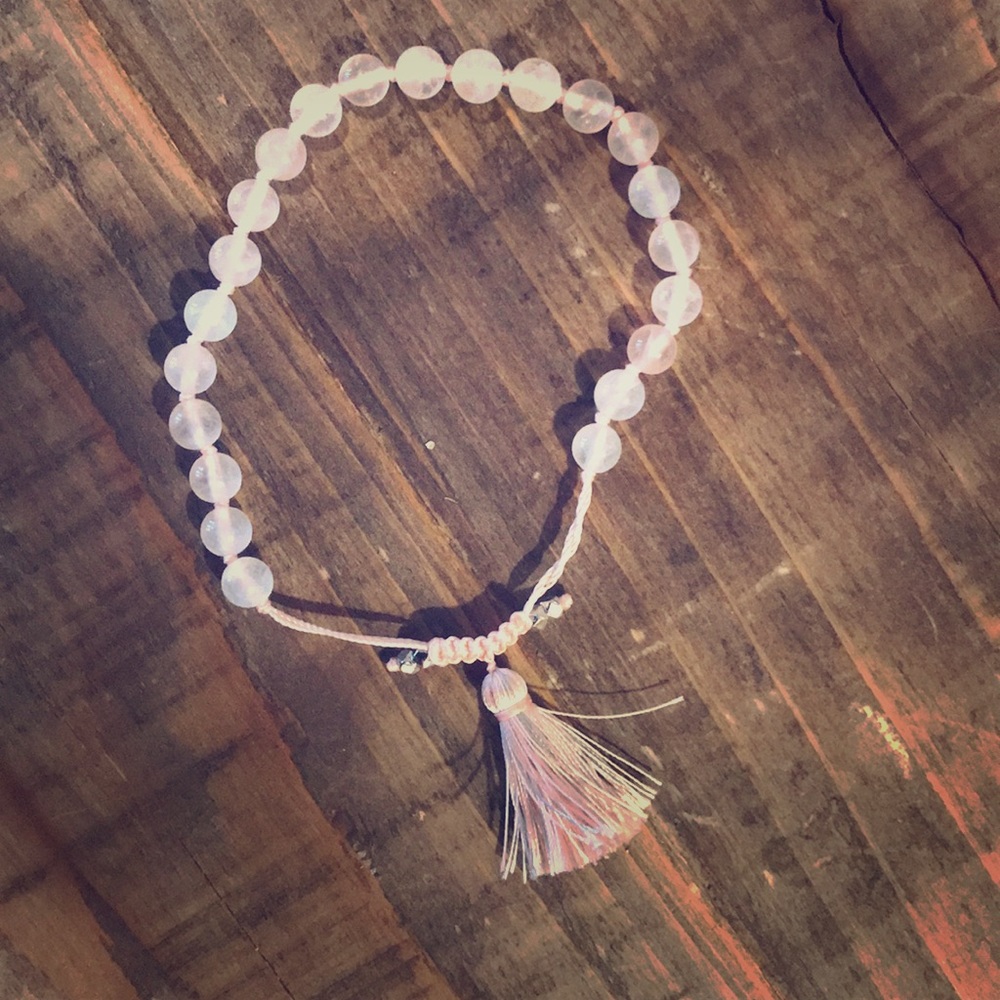 Pink quartz beaded bracelet with tassel.